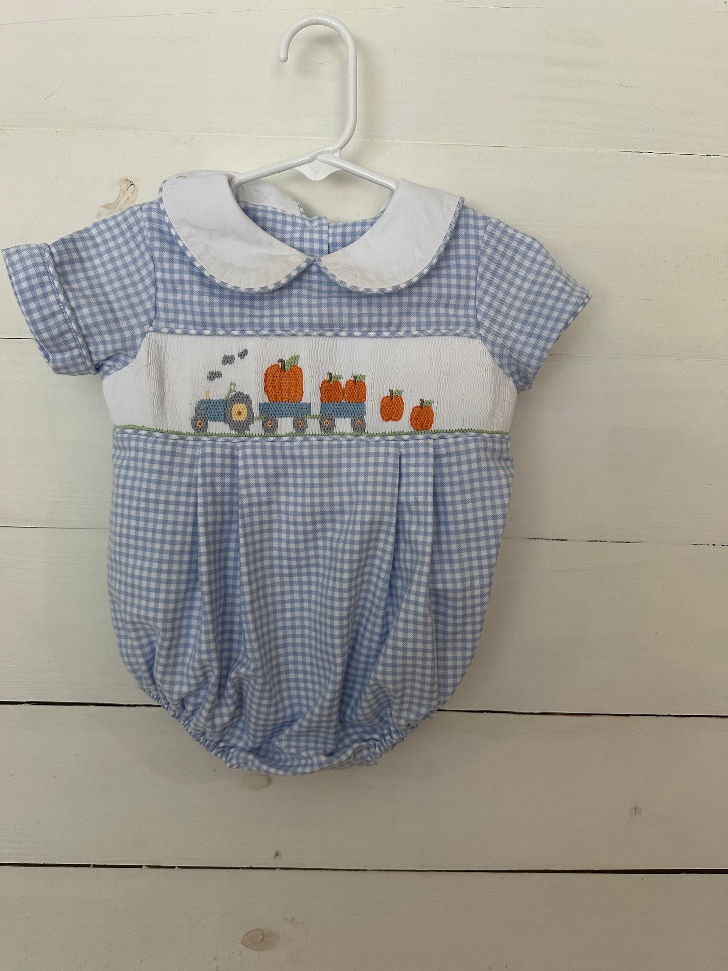 Shrimp & Grits Kids: Baby blue gingham bubble with pastel fall pumpkins, tractor, & wagons.