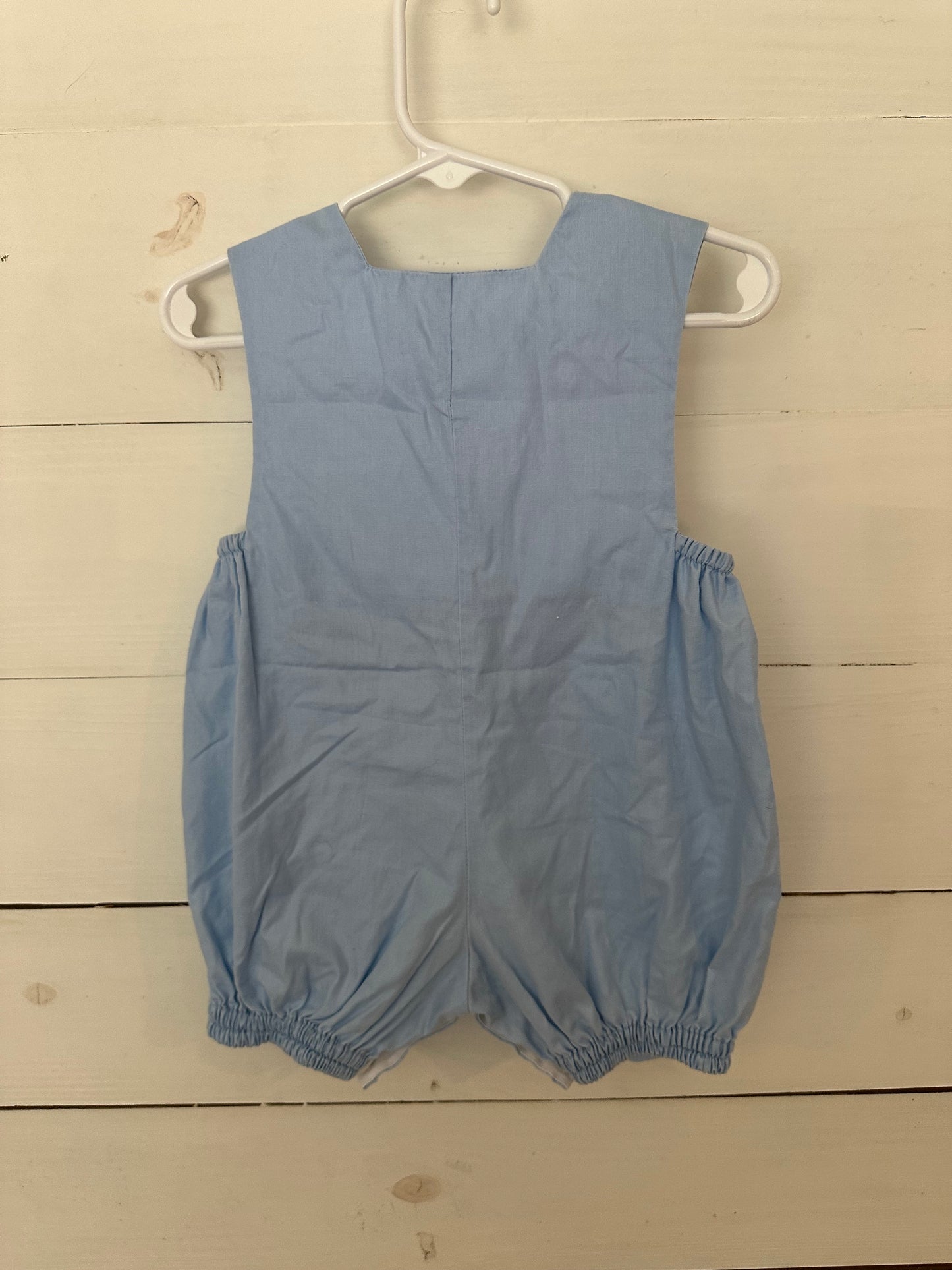 House of Hatten Inc: Light blue bubble with smocked trucks and button wheels