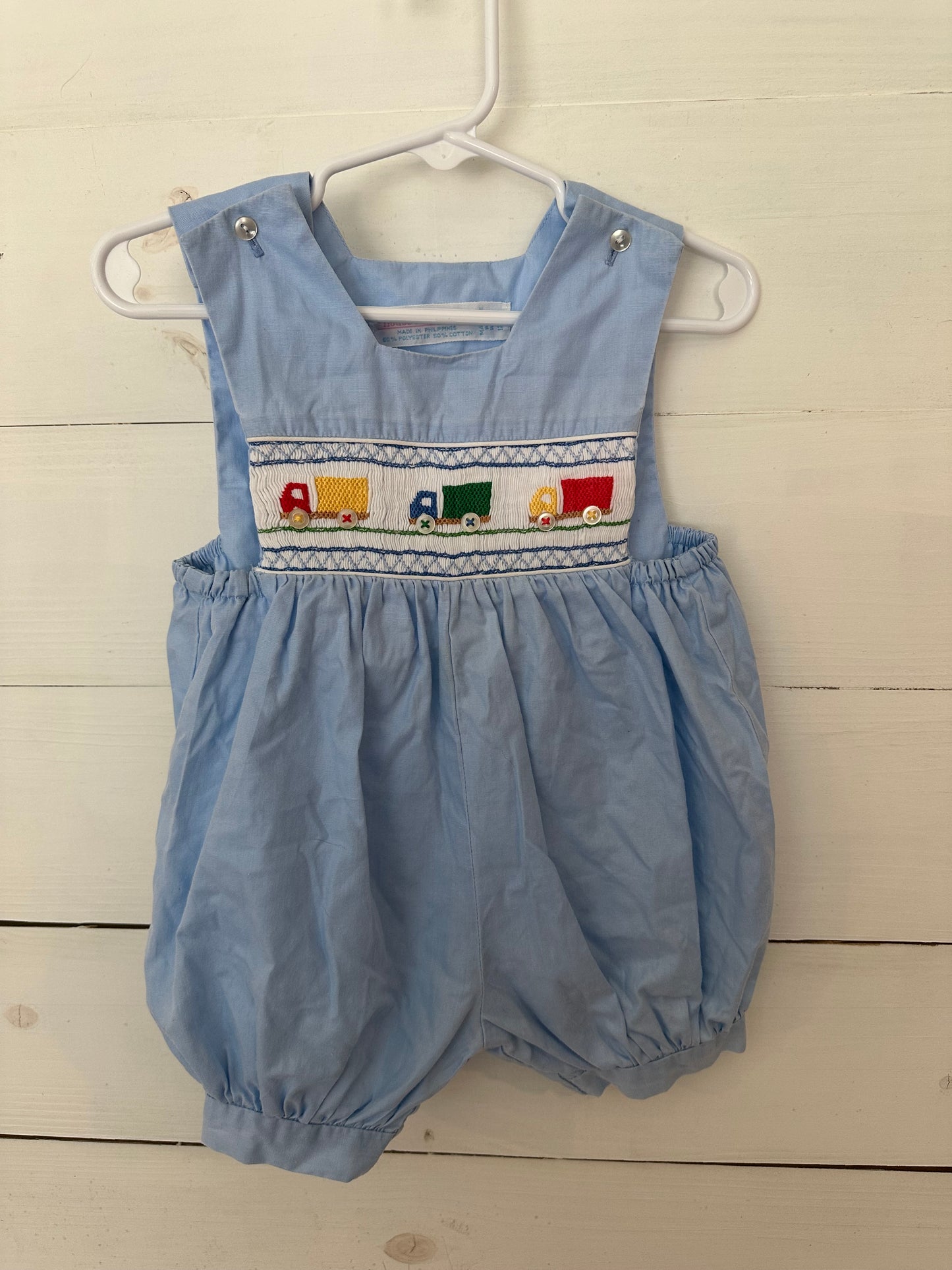 House of Hatten Inc: Light blue bubble with smocked trucks and button wheels