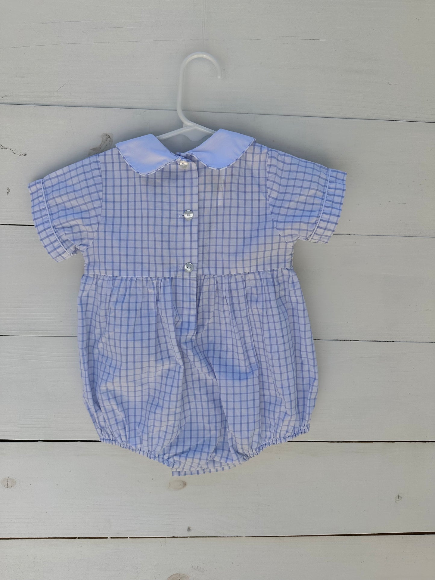 Petit Bebe: Light blue window payne bubble with smocked crabs and peter pan collar